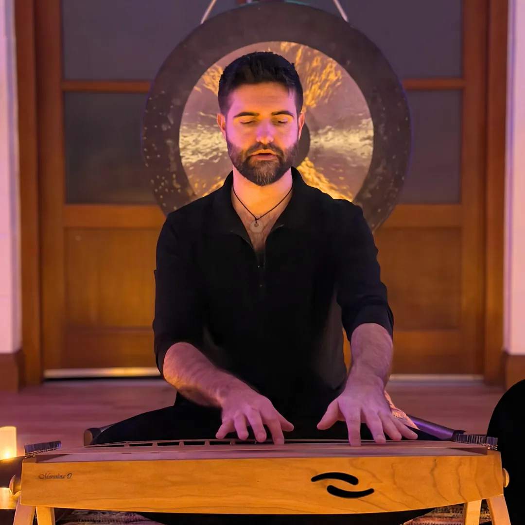 James Edwards facilitating a sound bath session with gongs and singing bowls